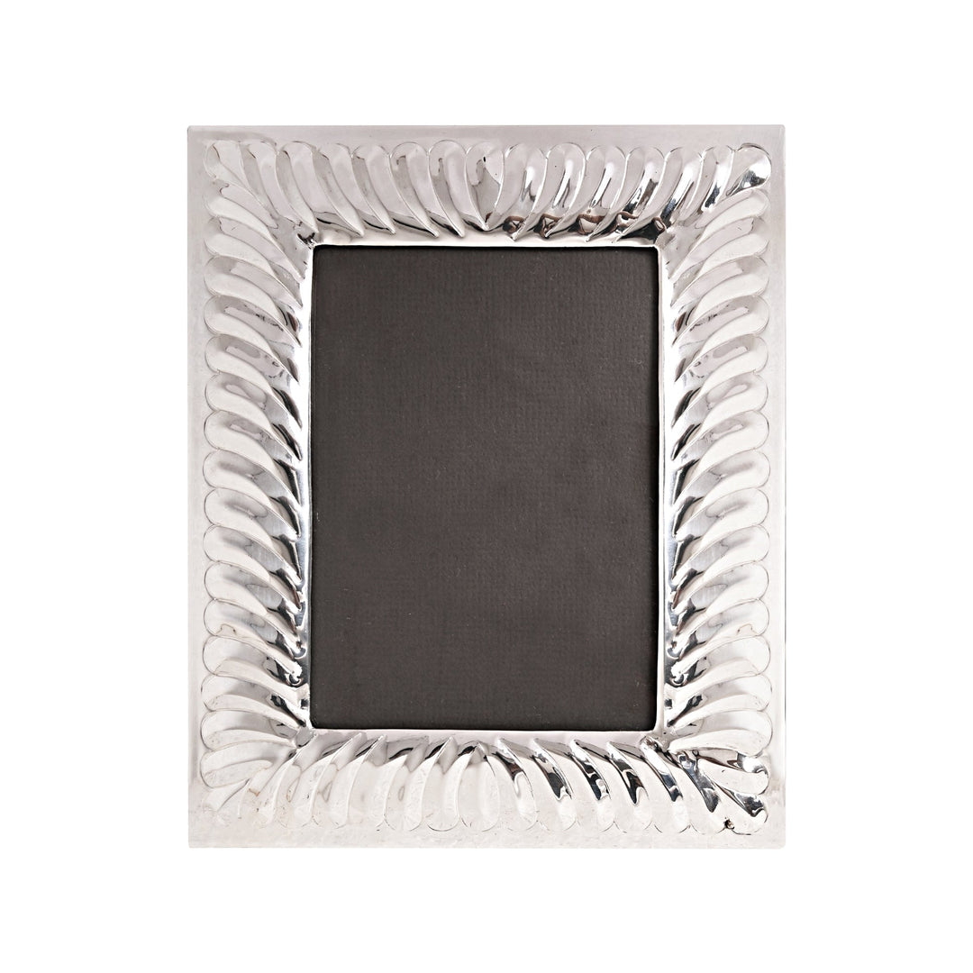 Photo Frame Italic is a silver frame that wraps every edge in a polished, swirling, feather-like fluted border that catches the light – Small (4x6)