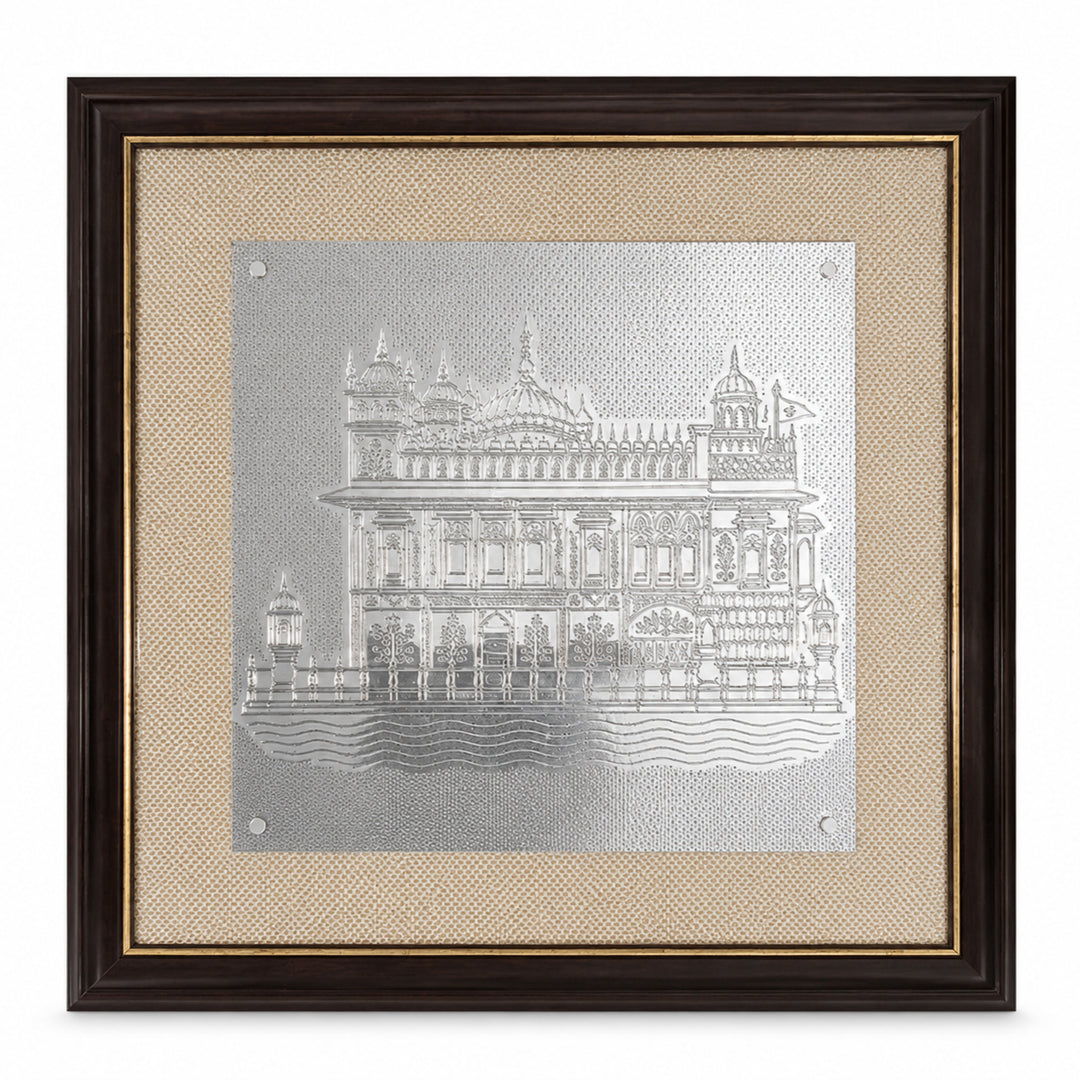 Golden Temple Wall Art is a silver Golden Temple panel in shallow relief, the Harmandir Sahib mounted on jute inside a dark wood frame with a gold inner fillet - white background