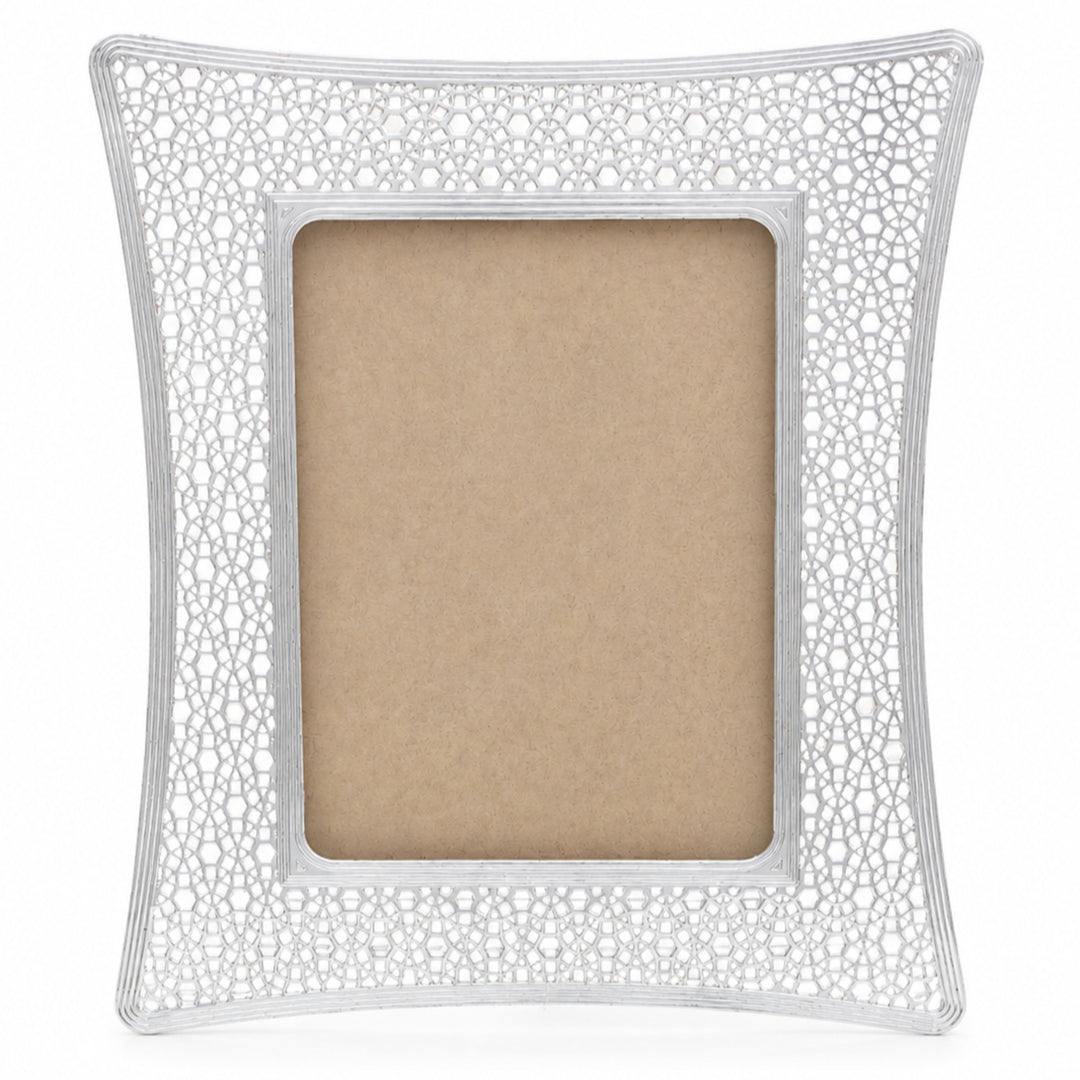 Mosaic Photo Frame Small is a silver photo frame with a waisted outline and a border pierced right through in a jali lattice of stars, hexagons and rosettes - white background