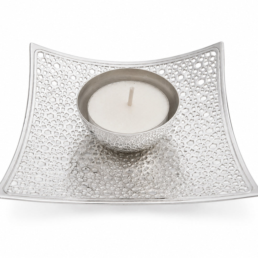 Mosaic Votive Holder is a silver tealight holder shaped as a shallow square dish, its whole field pierced with small polygonal cut-outs around a raised central candle cup - white background