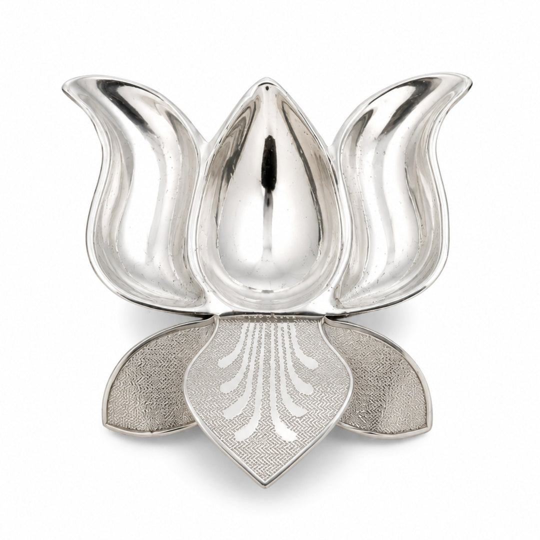 Neerja Diya is a silver diya shaped as a half-open lotus, with three polished petals enclosing a deep oil well over a textured lower tier - white background