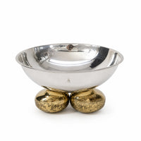 Pebble Bowl in its round form is a deep hemispherical silver bowl raised on two joined pebble feet finished in a warm brass tone - white background