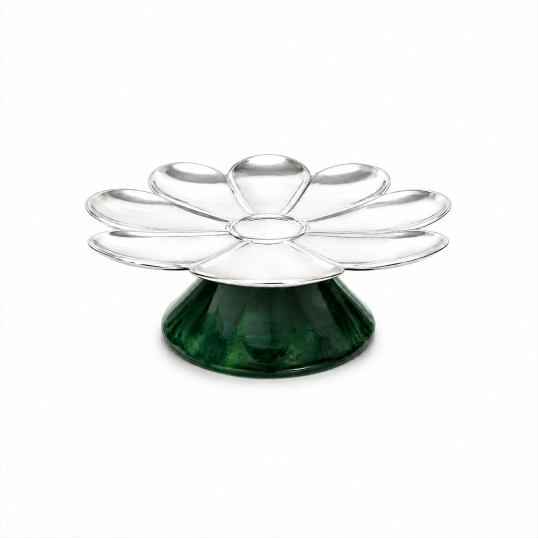 Rayon Bloom Platter is a silver platter with nine shallow petal wells around a small centre well, raised on a conical dark green stone pedestal - white background