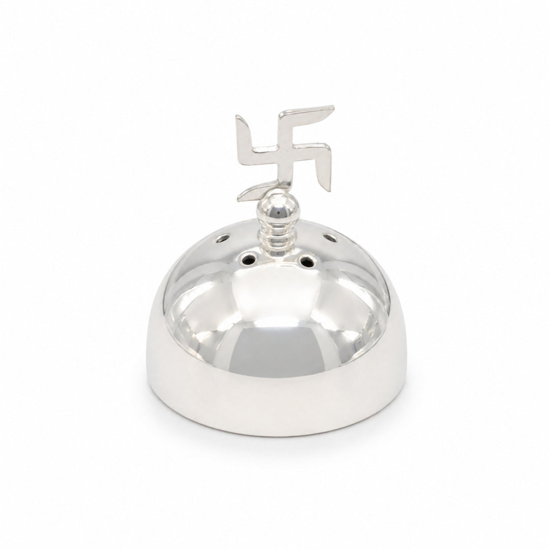 Swastik Incense Holder is a silver agarbatti stand with a polished dome drilled to hold sticks upright under a flat cut swastik - white background