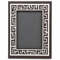 The Enigma Photoframe is a silver photo frame whose dark brown wood face carries a dense geometric fretwork maze border - white background