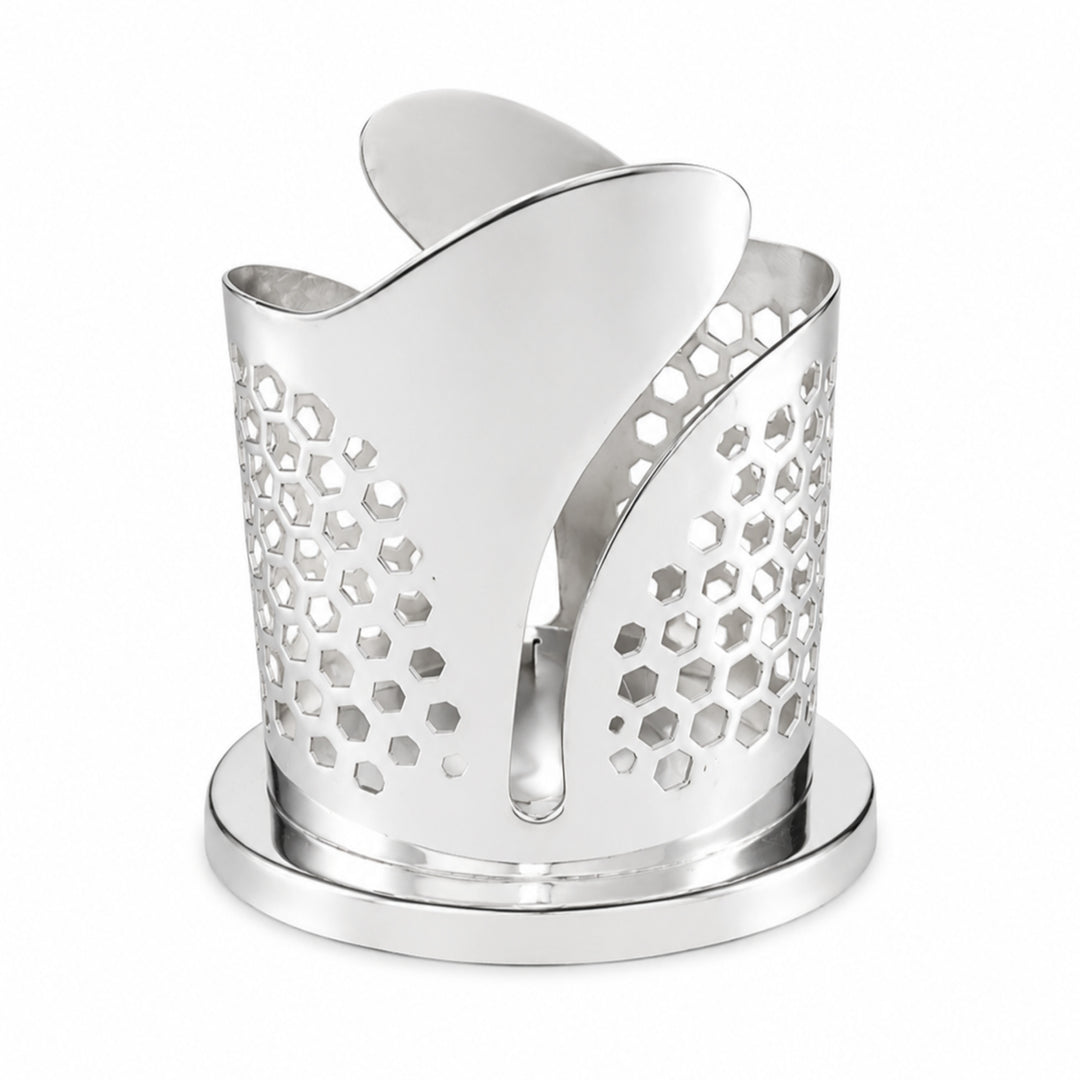 Tulip Votive Holder is a silver tealight holder built from three overlapping petals on a stepped oval plinth, the lower half of each petal pierced with graded hexagonal holes - white background