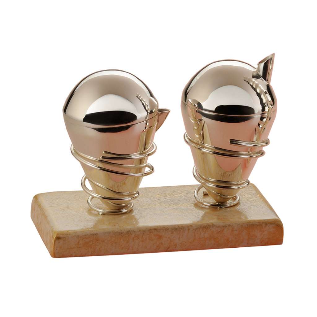 Milk And Sugar Spring is a silver creamer and sugar pot pairing, two plain cone-shaped vessels mounted in a coiled silver-wire stand - white background