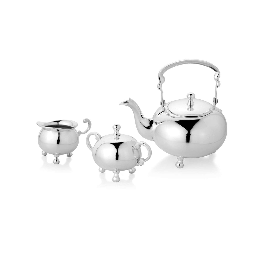 Tea Set Mandarin centres on a round, bulbous kettle-shaped silver teapot standing on four small ball feet - white background