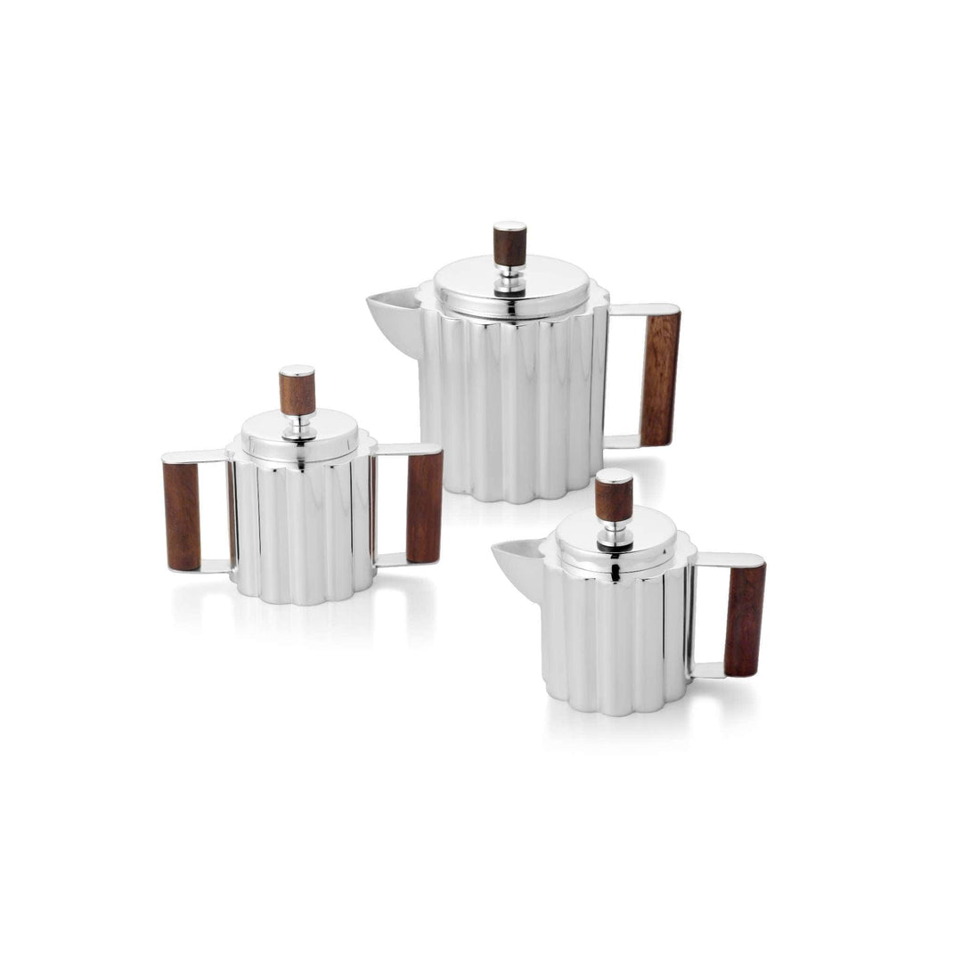 Tea Set Fluted is a silver teapot set with fluted, reeded cylindrical bodies - white background