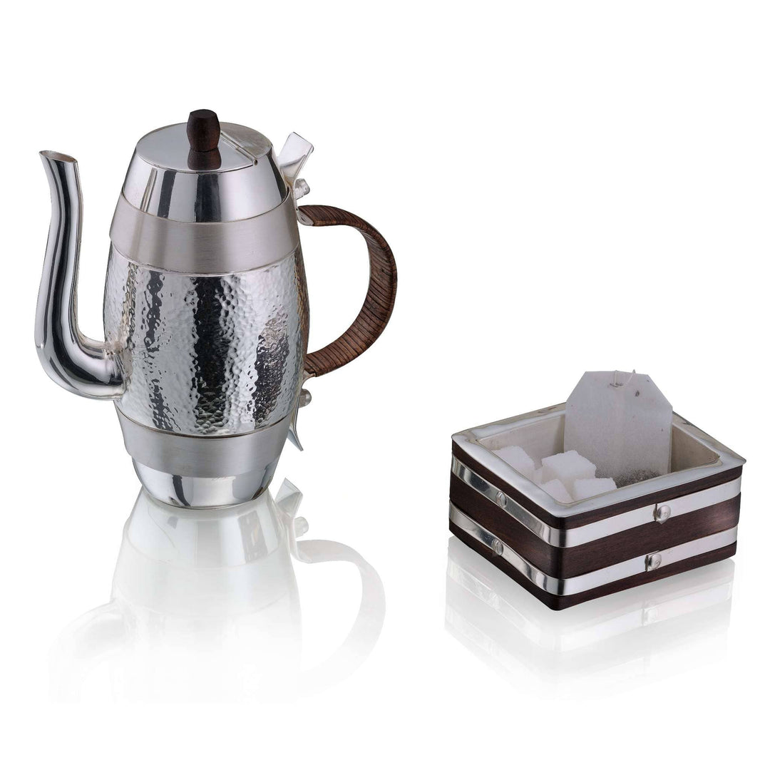 Tea Set Barrel is a silver teapot with a barrel-shaped body and a dense hammered texture - white background