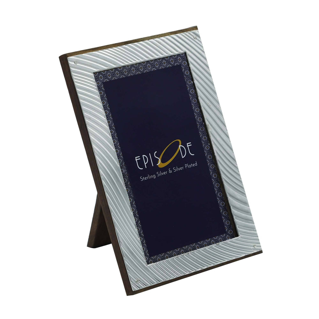 Photo Frame Fluid ripples in soft, radiating lines that curve around the picture opening of this silver frame - white background