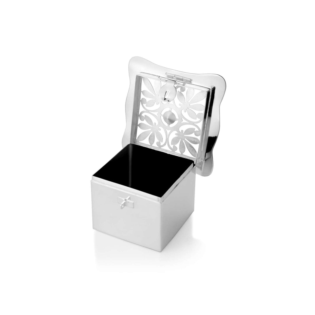 Box Beauty tops a square silver box with a lid framing a pierced floral medallion over black enamel - white background