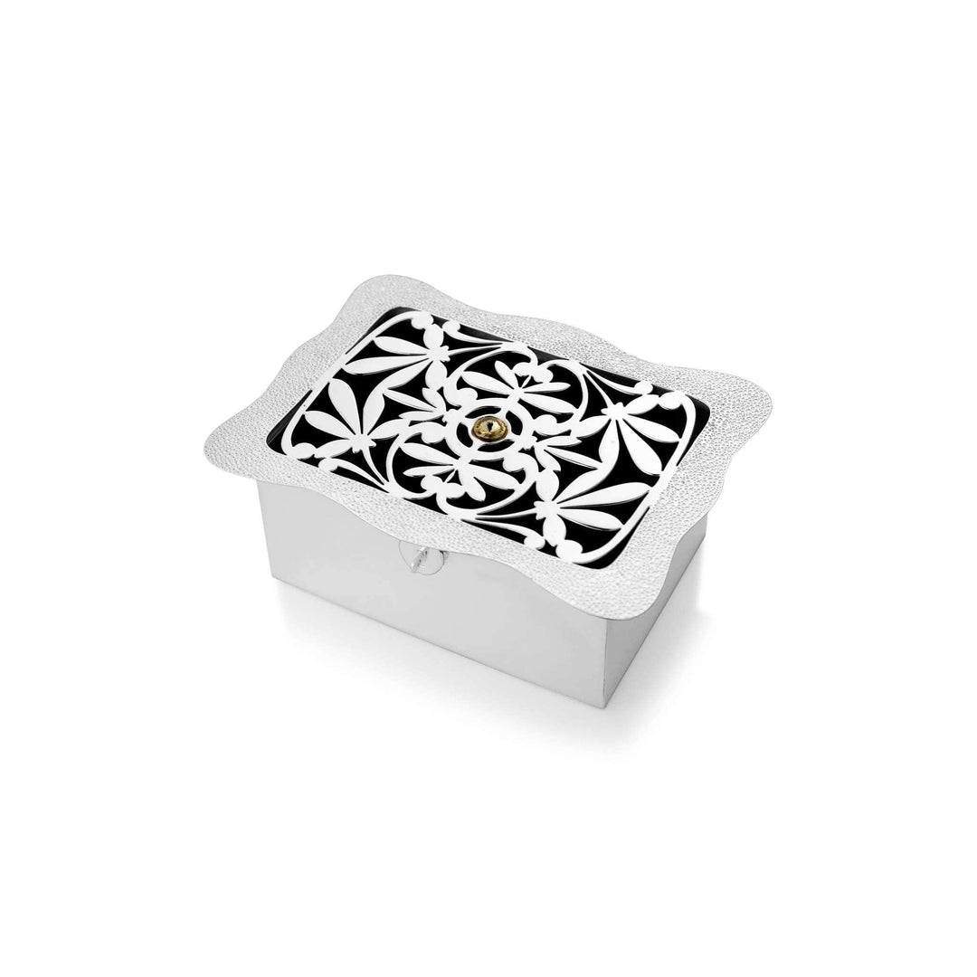 Box Grace tops a rectangular silver box with a lid framing a pierced fleur-de-lis medallion set over black enamel - white background