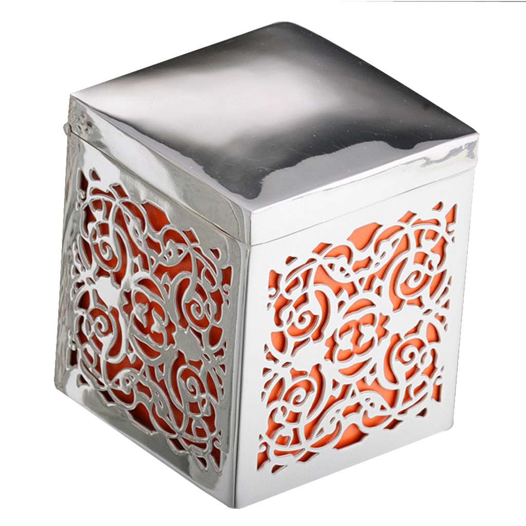 Box Maroc is a silver box shaped by Moroccan-inspired metalwork into a cube with scrollwork, with pierced sides backed in a warm coral tone - white background
