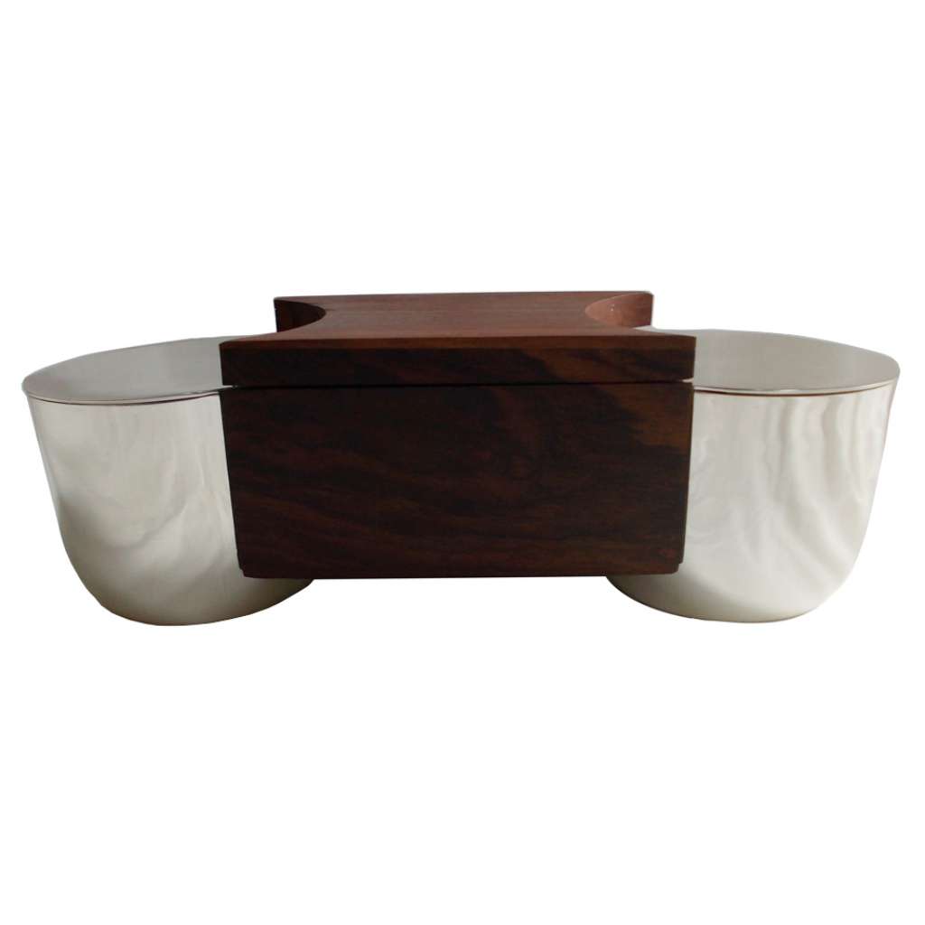 Box Double is a silver box joining two rounded bowls with a solid rosewood block at the centre - white background