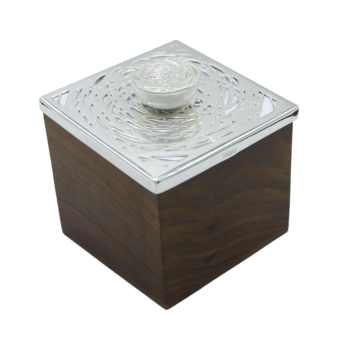 Box Cosmos is a silver box pairing a rosewood-toned body with a lid cut in an abstract, laser-etched swirl from Episode&