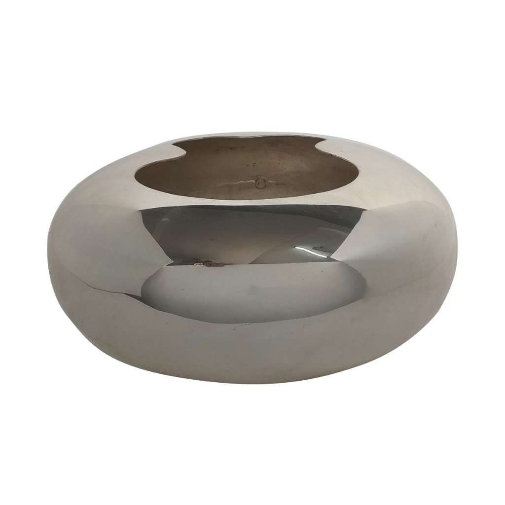 Flower Vase Cut Mouth is a silver vase that sits low and rounded like a smooth pebble, its top cut into a soft - white background