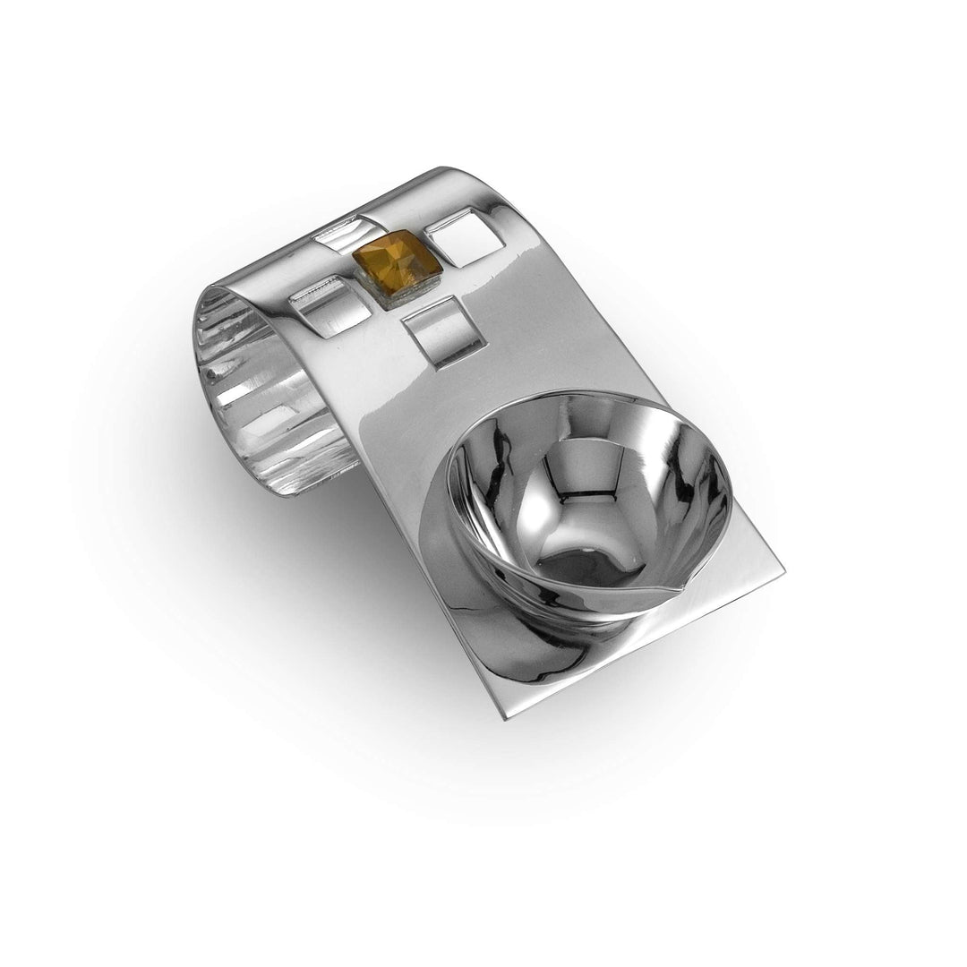 Diya Tilted is a silver diya that pairs a compact round oil cup with a raised, tilted plate cut through with small square windows - white background