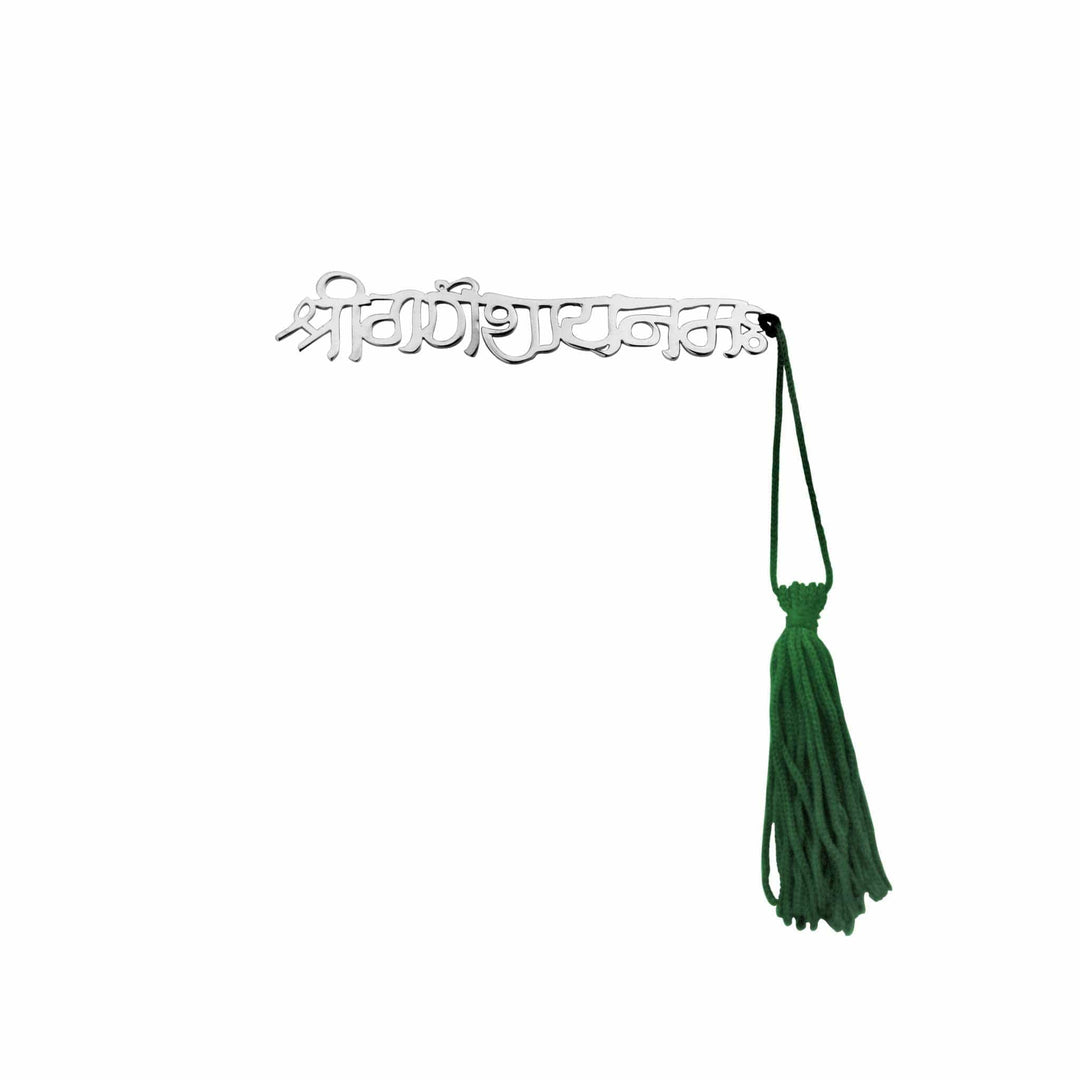 Bookmark Shubham is a silver bookmark that spells out Shubham, meaning auspicious, in polished script, paired with a green tasselled cord - white background