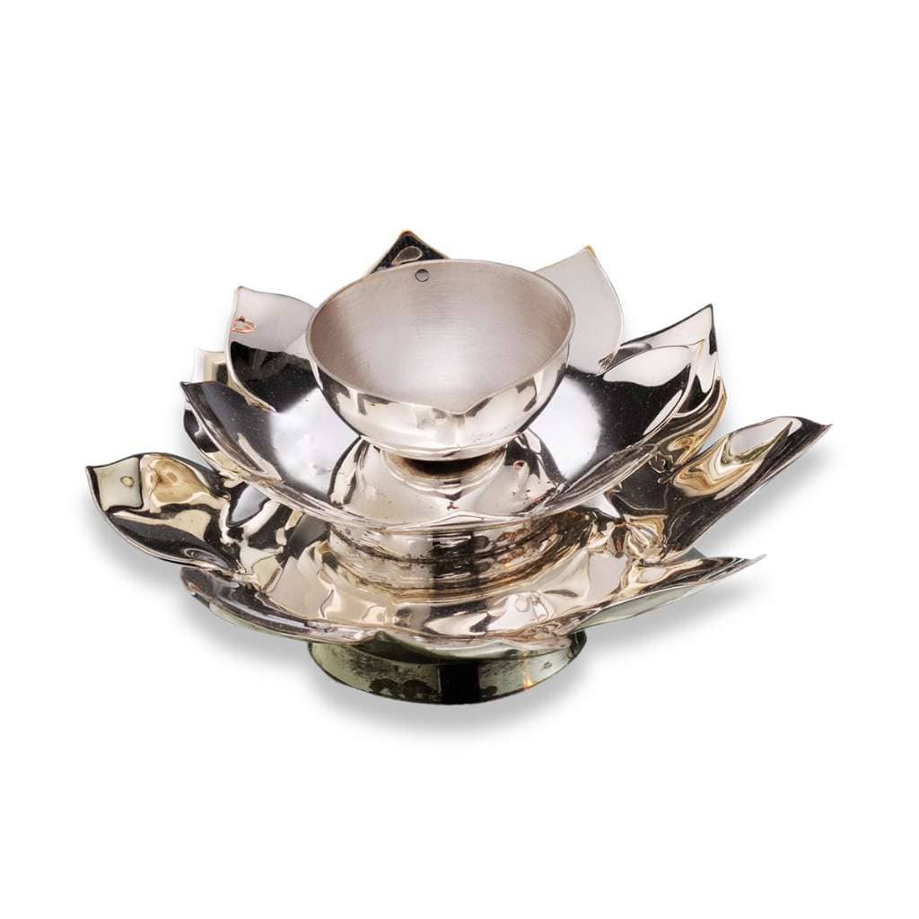 Diya Blossom is shaped like a lotus in bloom, a silver diya carrying its layered petals up to a single wick cup at the centre - white background