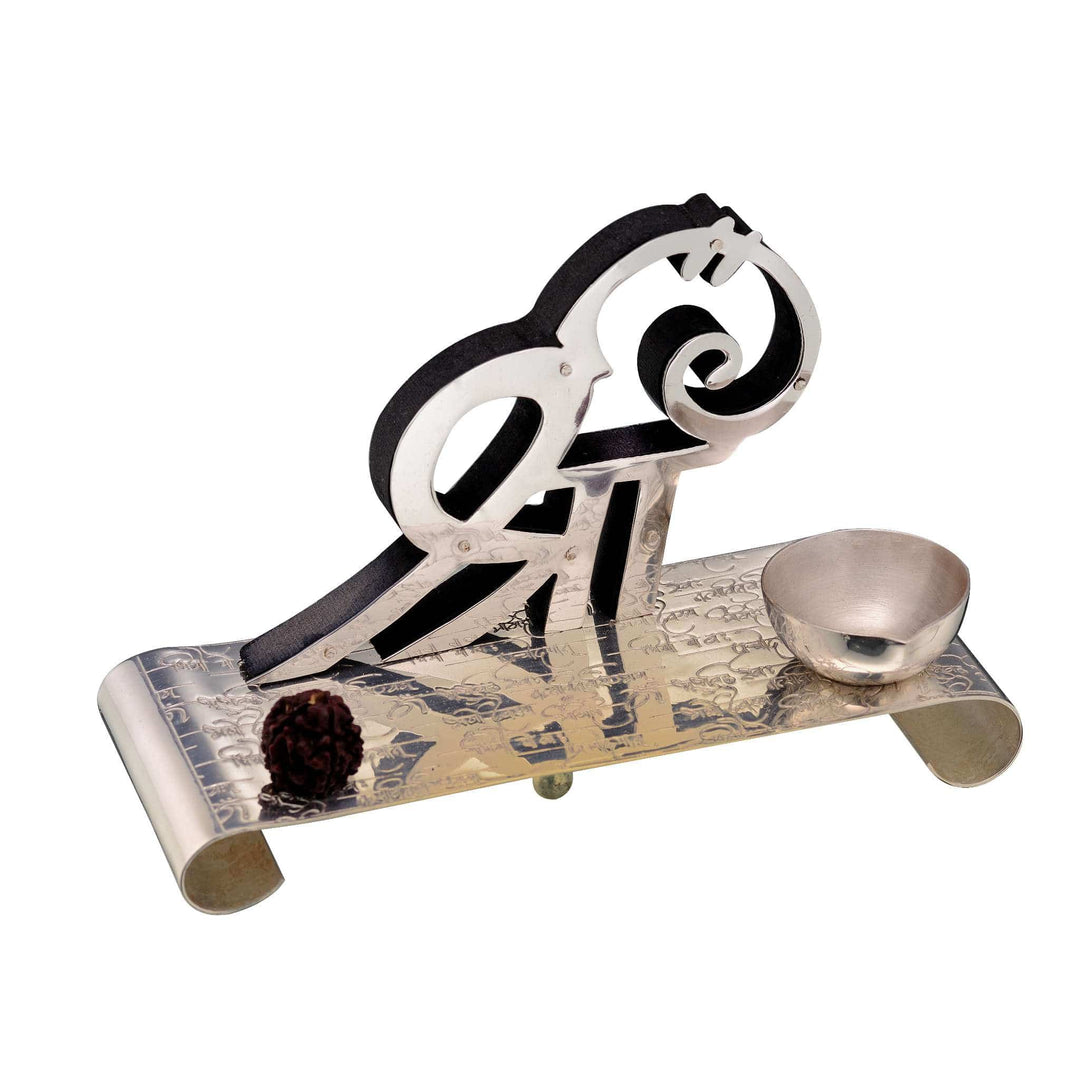 Diya Sri is a silver diya finished with a black enamel accent on its stylised Sri symbol - white background