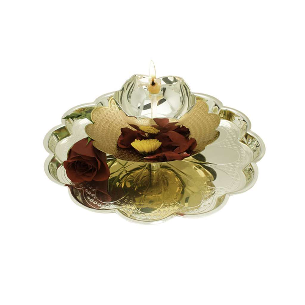 Akhand Jyot Radiance is a silver diya that sets a lotus-shaped candle cup at the centre of a scalloped, gold-toned tray - white background