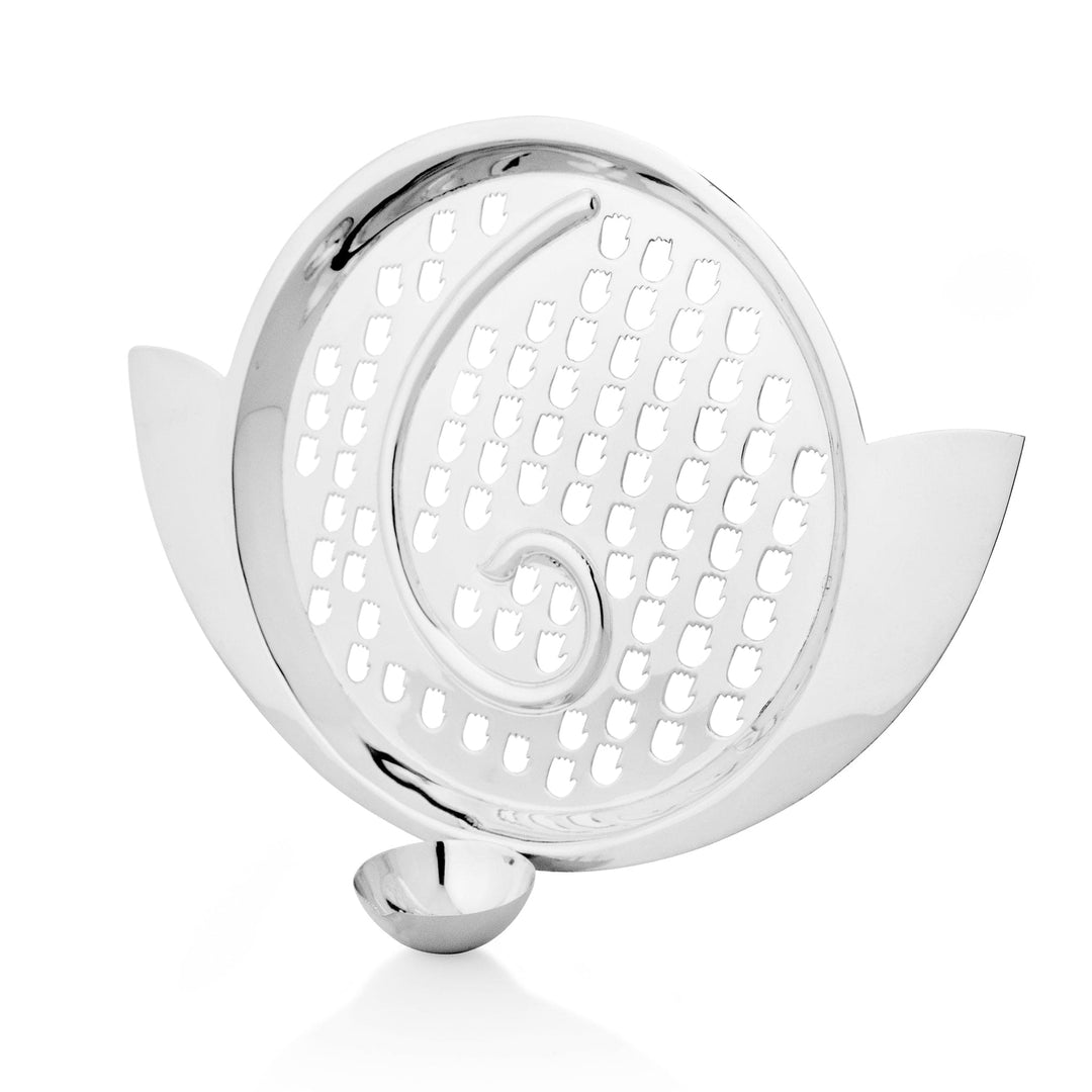 Sieve Blessing With Diya pairs a silver chalni, its lotus-edged rim pierced in a spiralling hand-motif pattern - white background