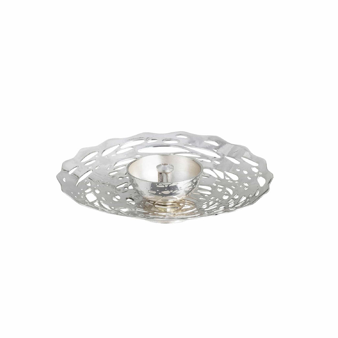 Tealite Holder Cosmos is a small silver tea light holder with a flat round base and a cosmos-flower pattern cut across the surface - white background