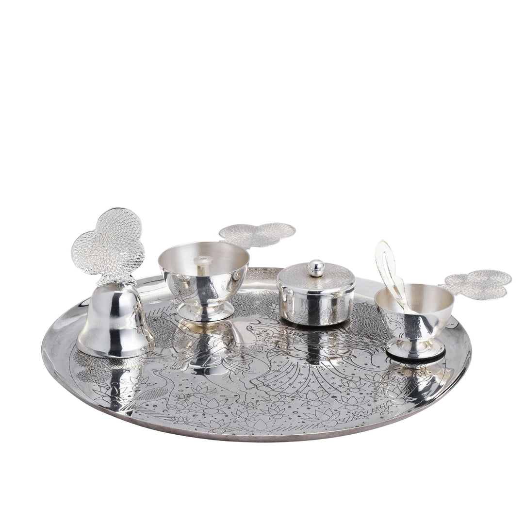 Pooja Thali Leela engraves a dancing Radha-Krishna scene under a flowering tree on a silver pooja tray - white background