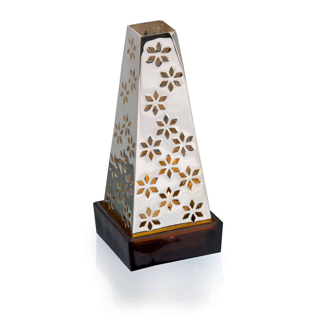 Light Holder Pyramid tapers into an obelisk-shaped silver light holder, its four sides pierced in a repeating star and diamond floral motif - white background