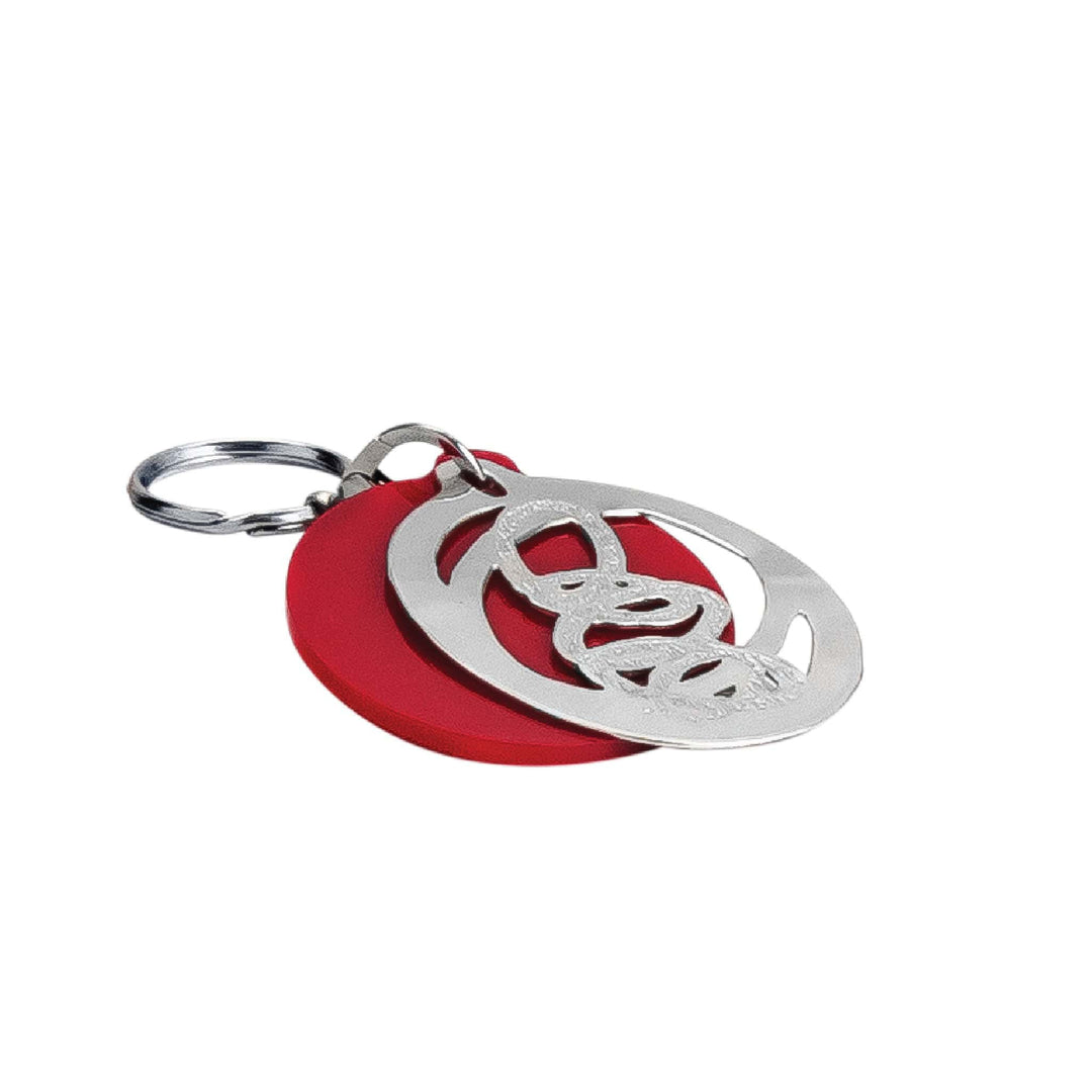 Key Chain Cosmos is a silver key chain layering a cut-out cosmic swirl design over a red enamel backing disc - white background