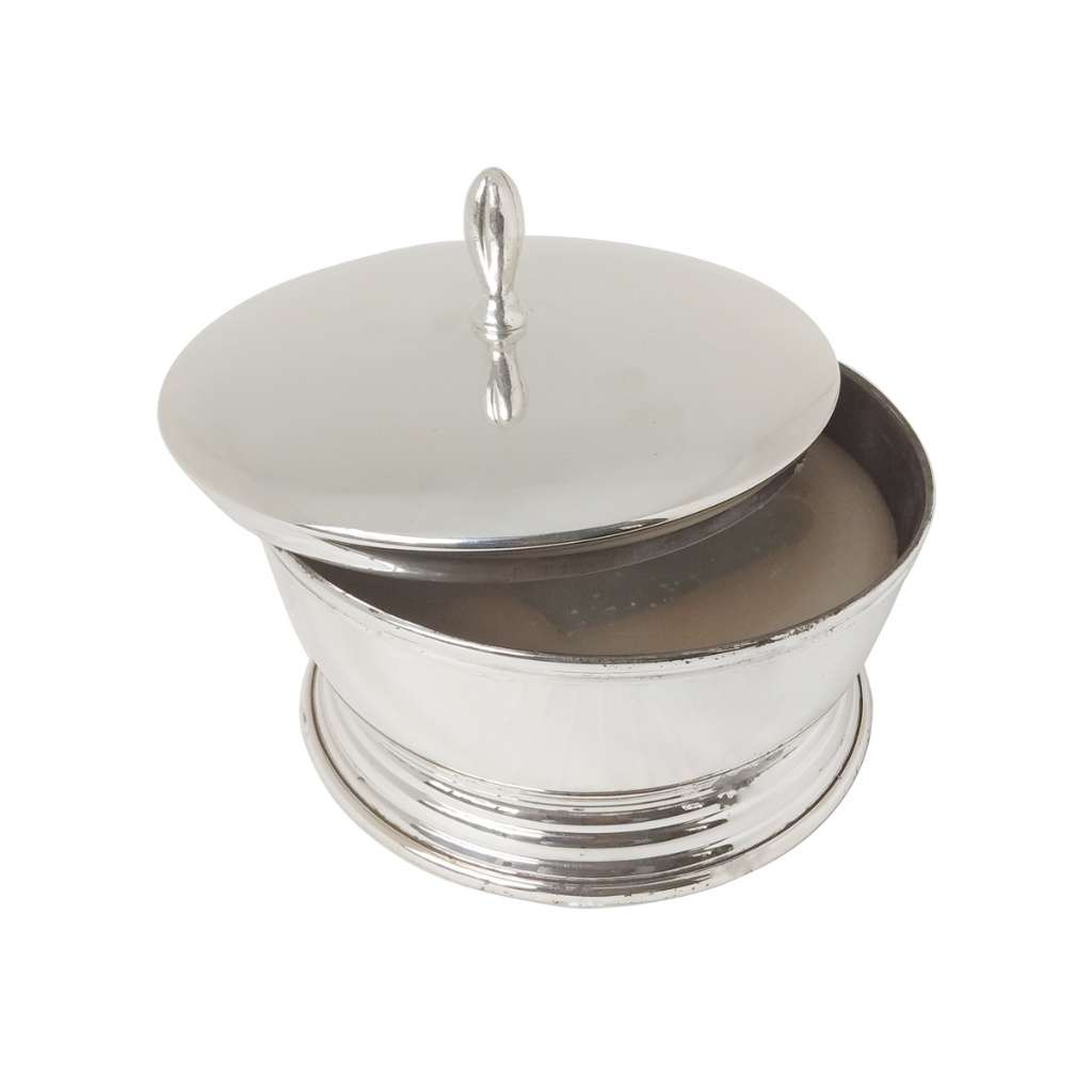 Bowl With Cover With Wax tops a silver bowl with a domed lid and a polished finial, set on a stepped - white background