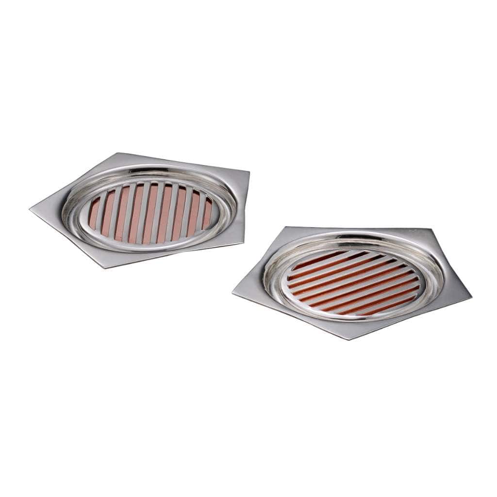 Coaster Chasm reveals a warm copper tone through an oval slatted insert set into the kite-shaped base of each silver coaster in this pair - white background