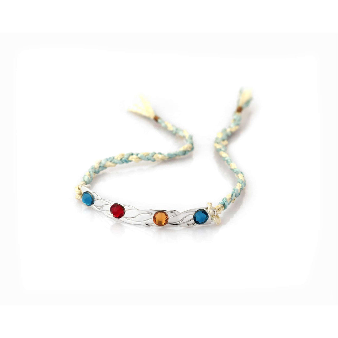 Rakhi Aura is a silver rakhi with four coloured stones set along a twisted bar on a cream and mint braided thread. - white background