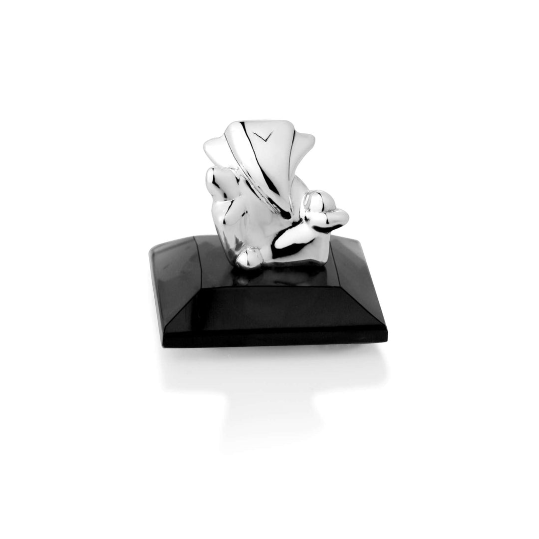 Ganesh Bal Ganesha builds a small sterling silver Bal Ganesha idol almost entirely from angular triangular facets, giving the young - white background