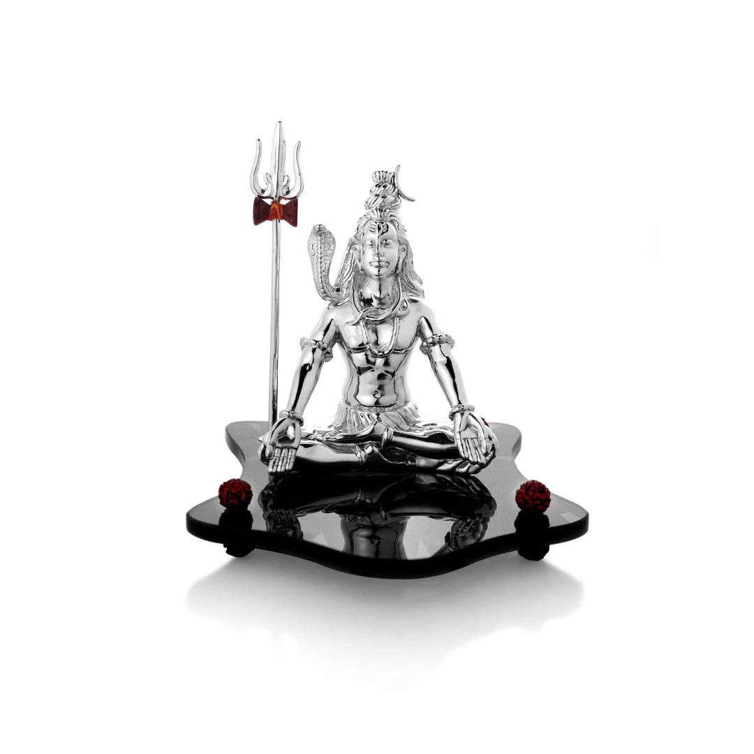 Meditating Shiva is a sterling silver Shiva idol seated in deep meditation, palms resting open on his knees - white background