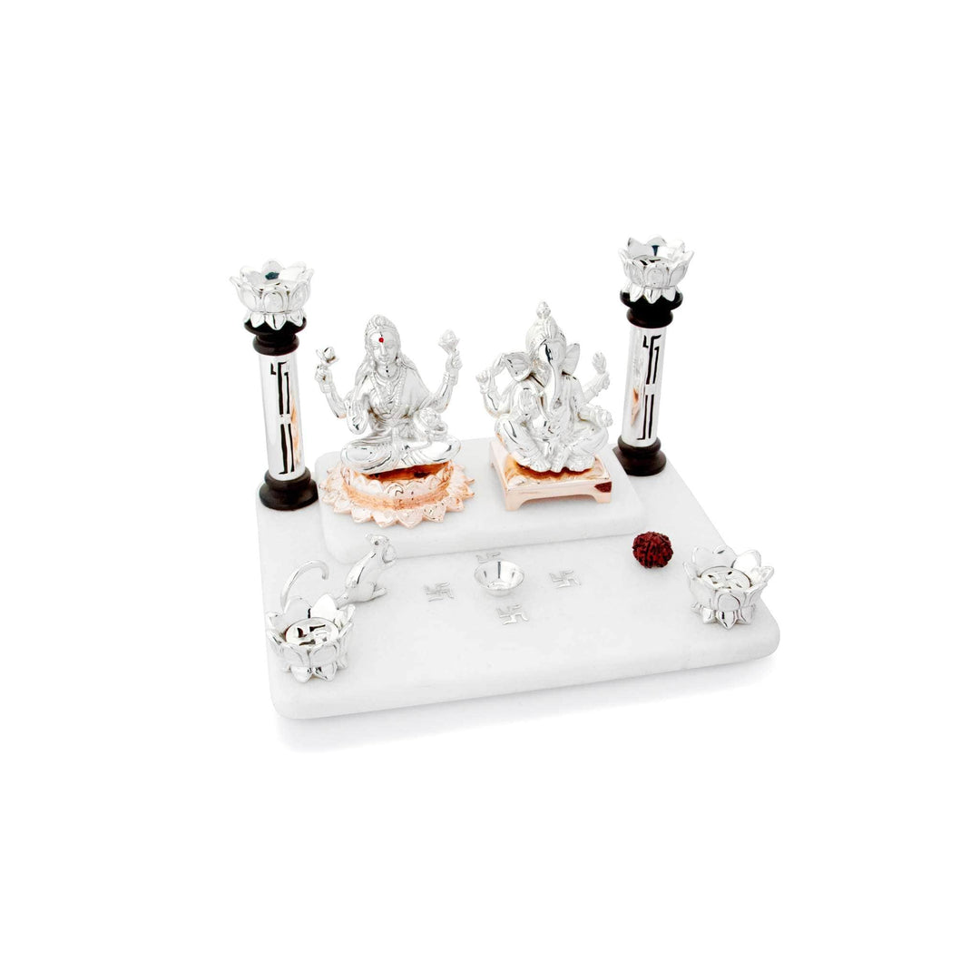 Mandir Vinayak sets sterling silver idols of Lakshmi and Ganesha on rose gold pedestals atop a two-tier white marble platform - white background