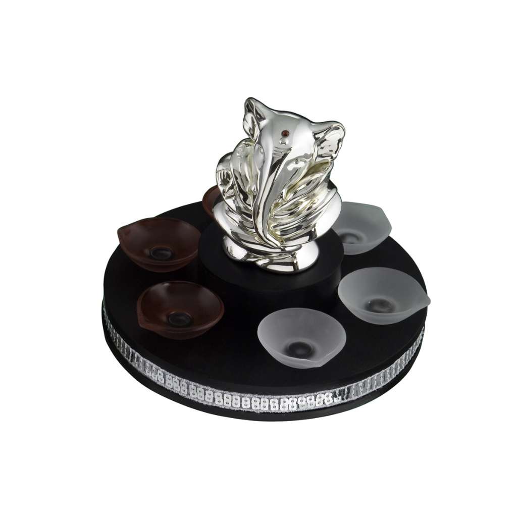 Ganesh Bud takes the form of an unfurling bud, a silver Ganesha bust rising from swirling, petal-like - white background