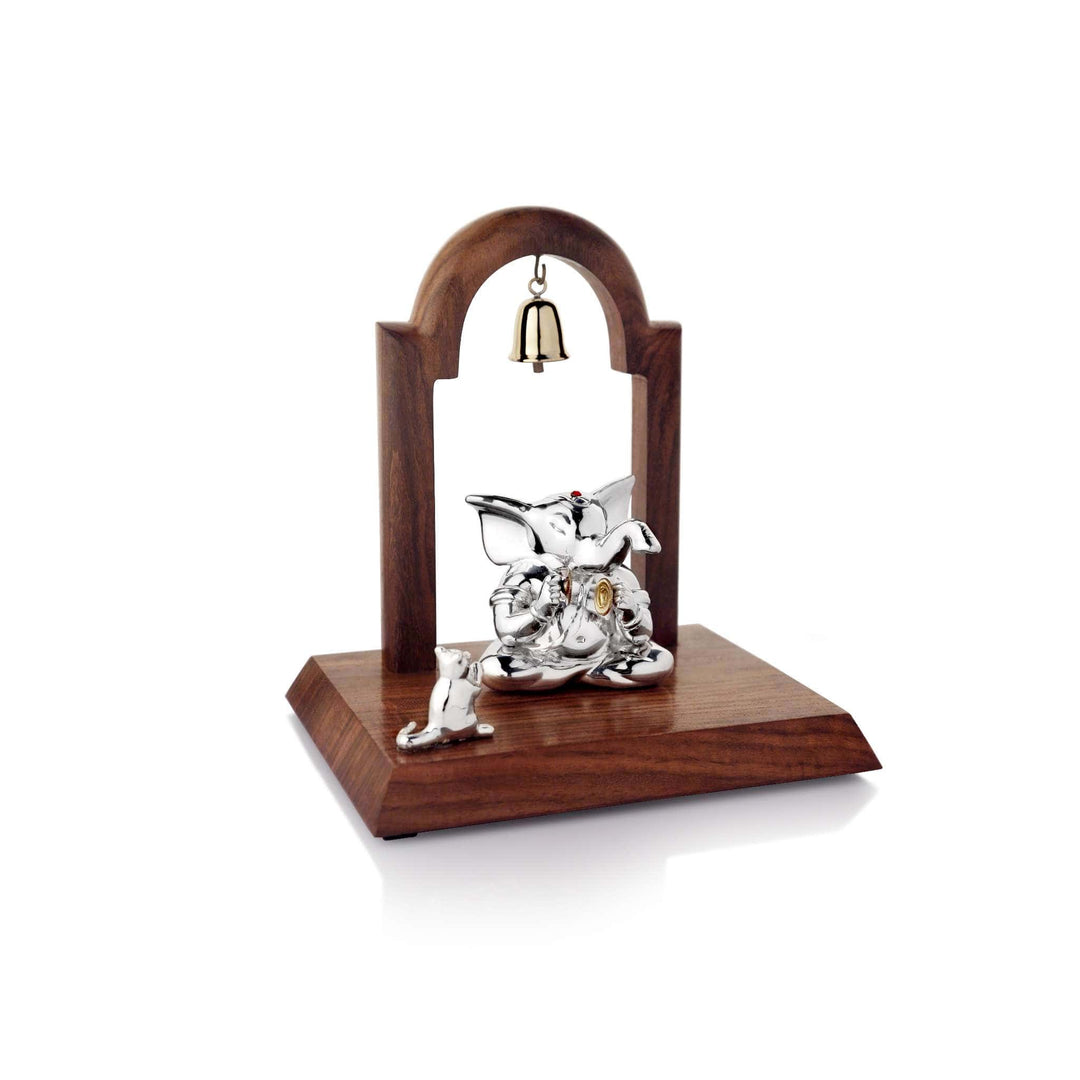 Ganesh Manjira seats a sterling silver Ganesha idol cross-legged - white background