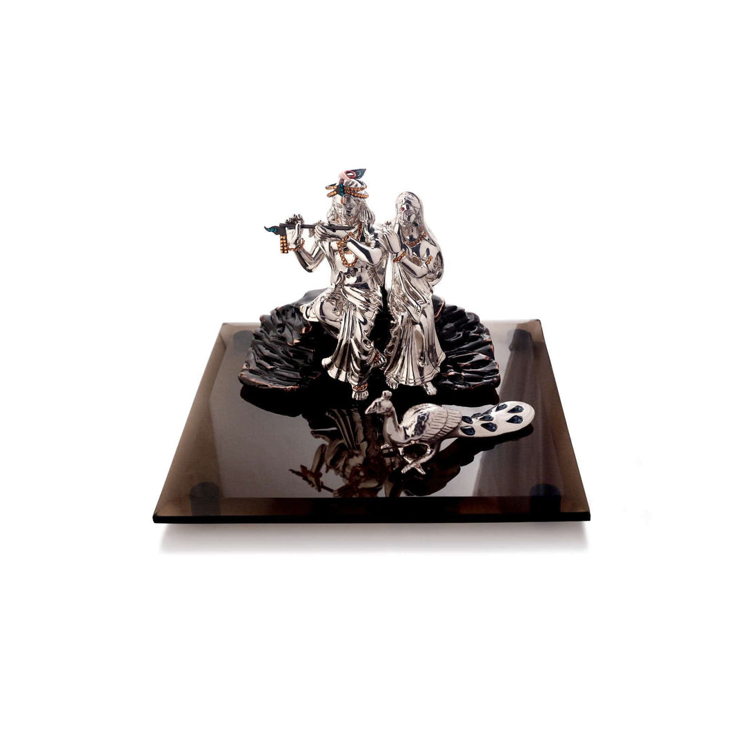 Radha Krishna Magna is a sterling silver idol bringing Radha and Krishna together on a rock formation - white background