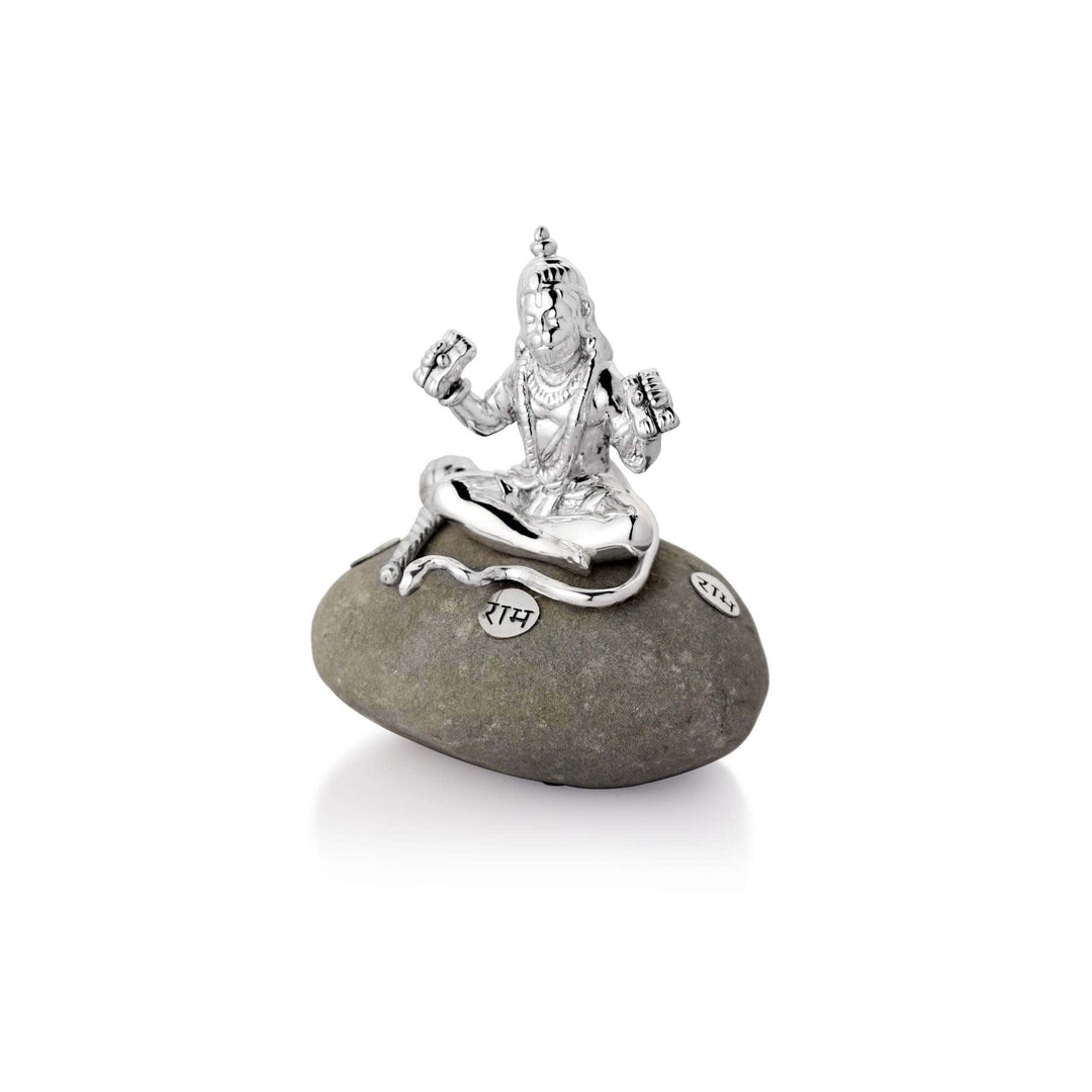 Hanuman On Stone sits a sterling silver Hanuman idol cross-legged on a natural pebble - white background