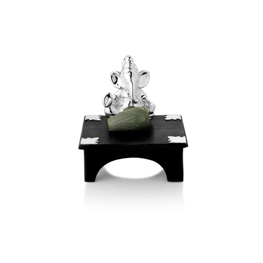 Ganesh Dholak shows a sterling silver Ganesha idol playing a dholak carved from cool green aventurine stone - white background