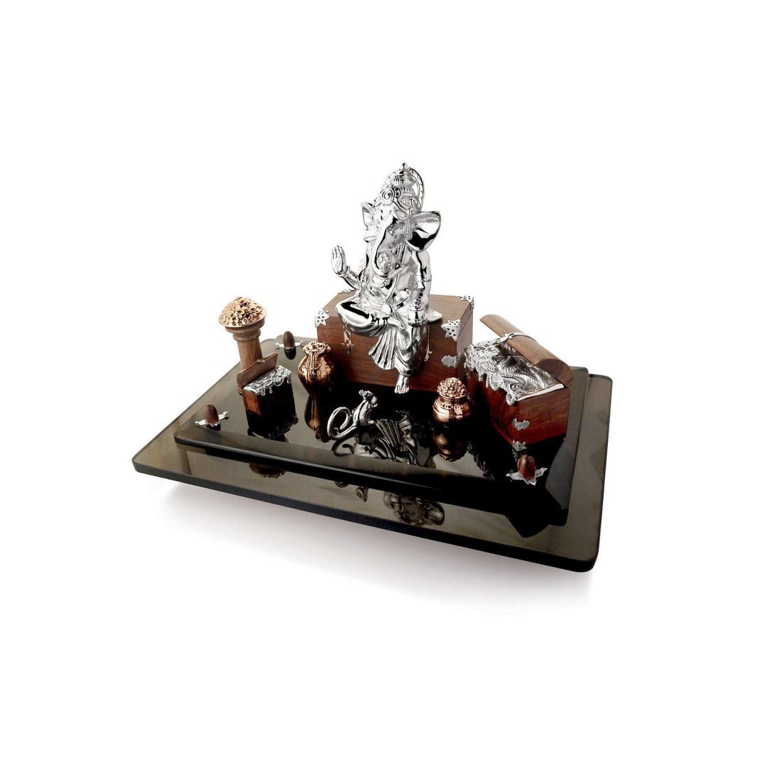 Ganesh Nidheshwaram, styled as lord of treasures, seats a sterling silver Ganesha idol on a wooden chest with silver corner fittings - white background