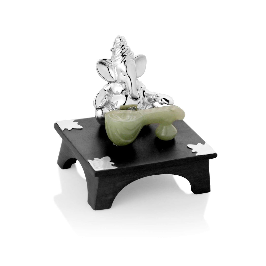 Ganesh Sitar shows a sterling silver Ganesha idol absorbed in playing a sitar carved from soft green stone - white background