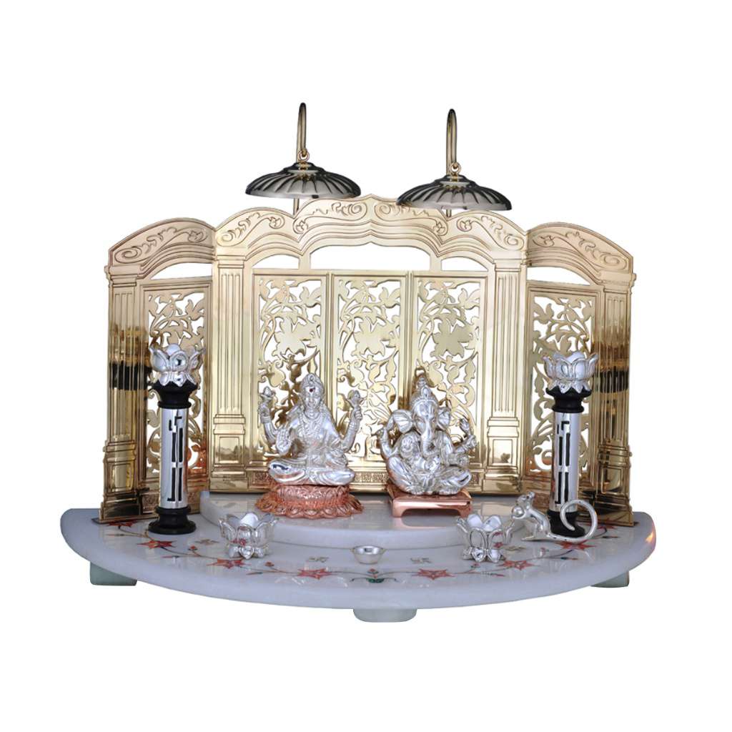 Mandir Smriddhi, a sterling silver mandir set, pairs a gold-toned brass screen, its three arched panels cut with a floral vine pattern - white background