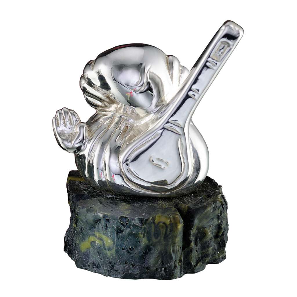 Ganesh Suveena reduces Ganesha to a rounded, abstract silhouette cradling a veena in one arm with the other hand raised in blessing, set on a rough-cut stone base - white background