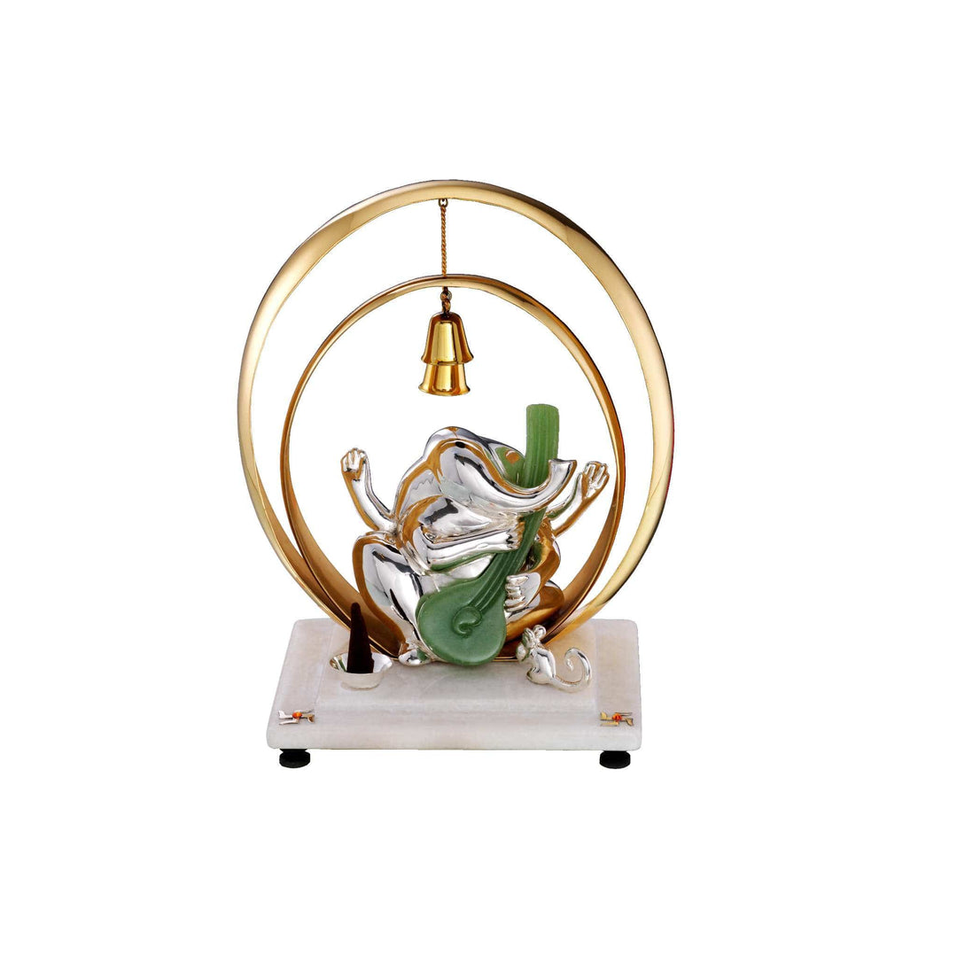 Ganesh Srishti captures a sterling silver Ganesha idol mid-dance, arms raised and playing a green stone veena - white background