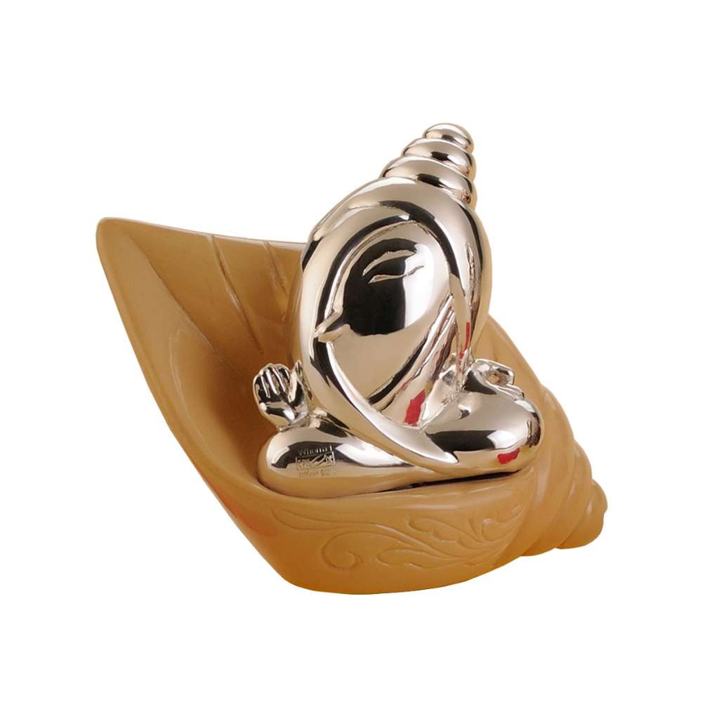 Ganesh Jalaj seats a sterling silver Ganesha idol inside a sculpted conch shell base - white background