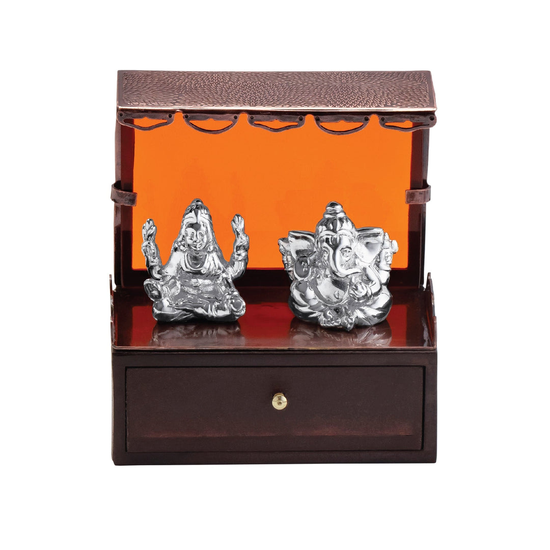 Laxmi Ganesh Niwas is a sterling silver Ganesha idol seated with Lakshmi inside a small wooden mandir box - white background