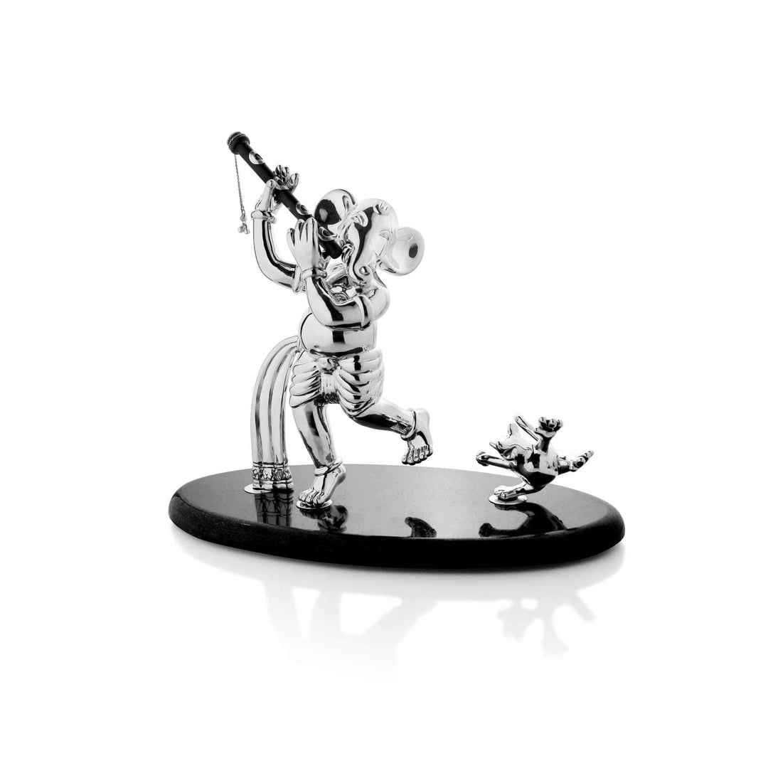 Dancing Ganesh catches a sterling silver Ganesha idol mid-dance, one leg raised and both hands lifting a flute – Small